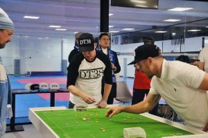 Adrian Connolly taking on Melbourne City FC captain Scott Jamieson in an Anzac Eve exhibition table football match to raise awareness for testicular cancer.